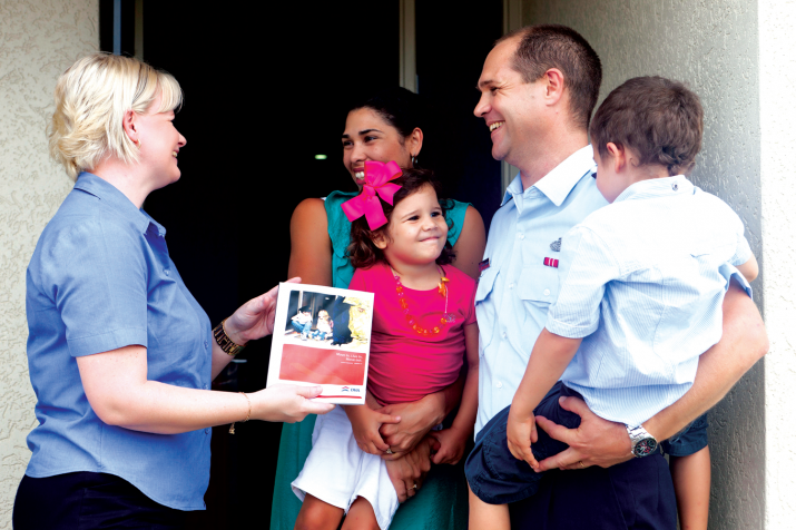 Photo - A DHA Property Manager visits a RAAF family at their DHA home. The staff member presents the family with a Tenant Handbook. Photo - A DHA Property Manager visits a RAAF family at their DHA home. The staff member presents the family with a Tenant Handbook.