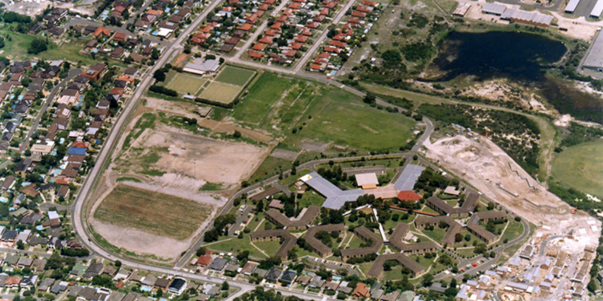 Aerial photograph of the Moverly Green area showing old Defence buildings amongst vast areas of undeveloped land. Surrounding roads are lined with houses.