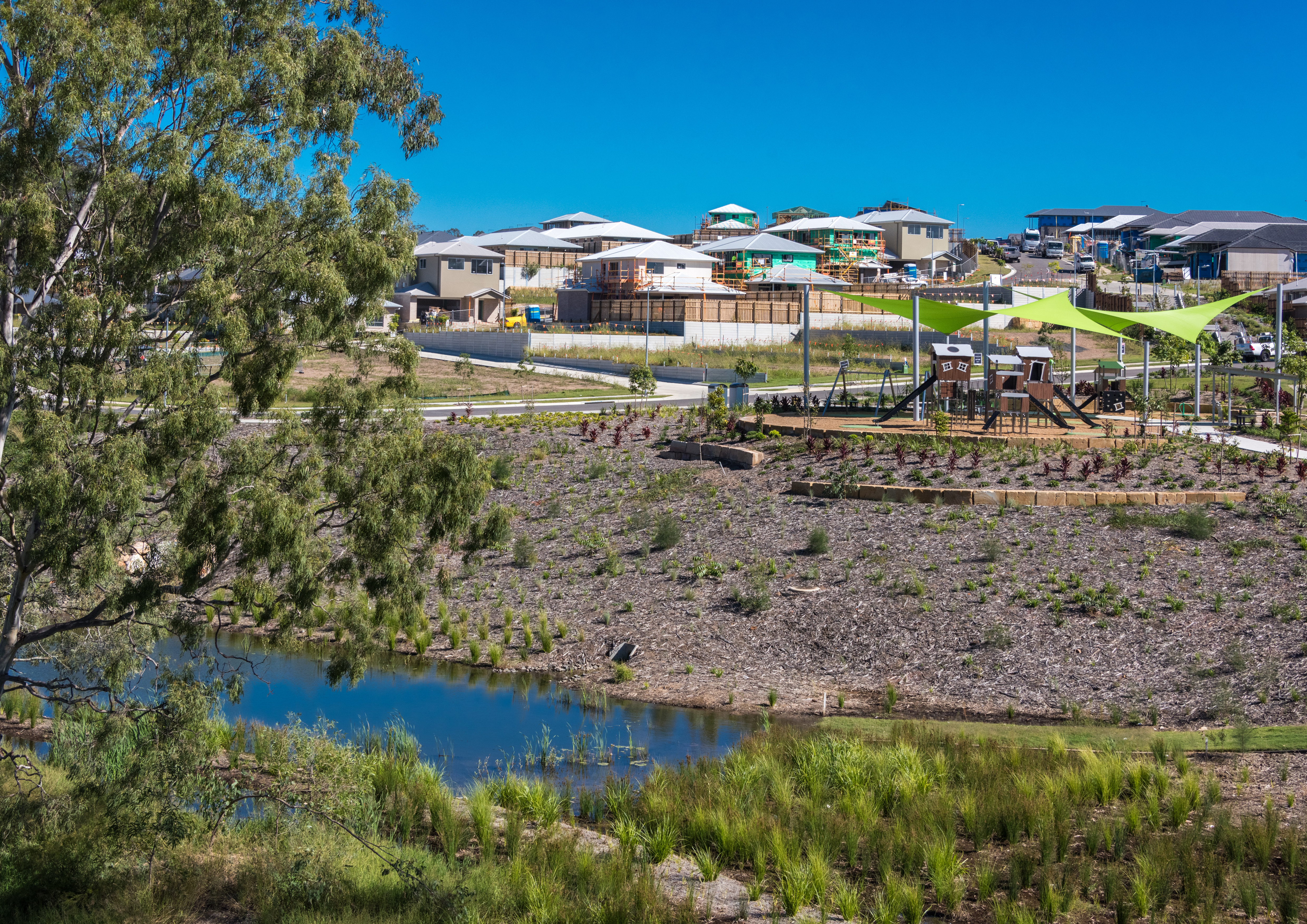 View of the Torhaven park and playground over a creek