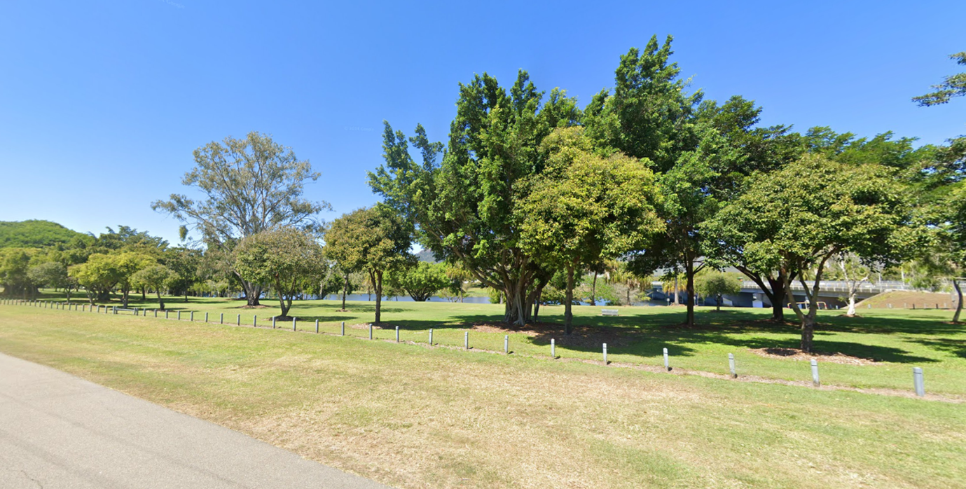 Green landscape showing trees, grass and a river in the background