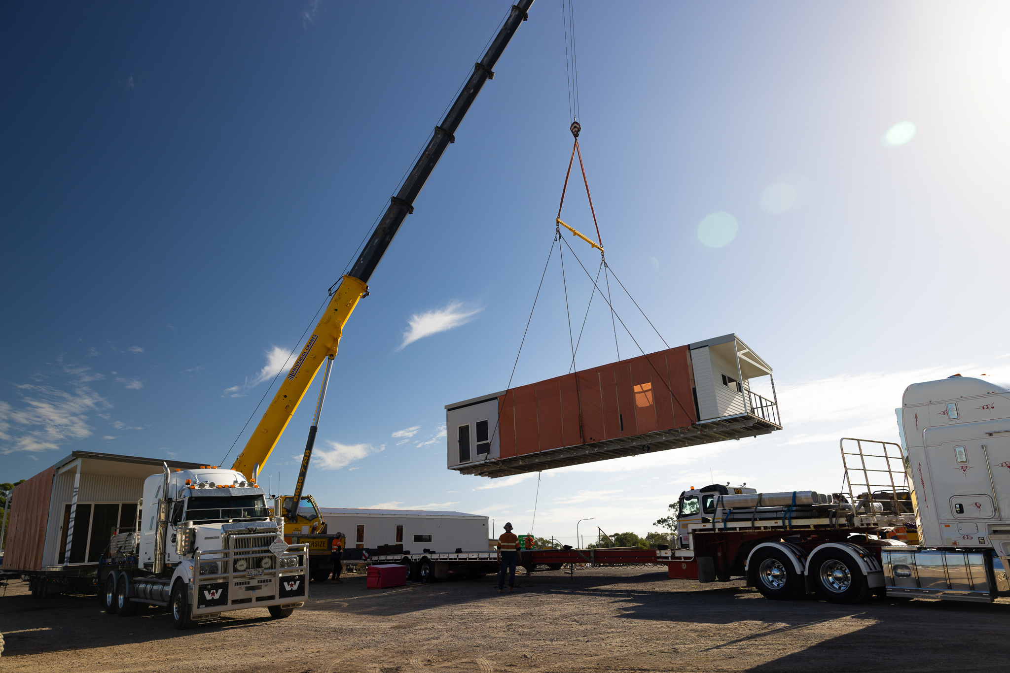 House being carried by crane, mid air