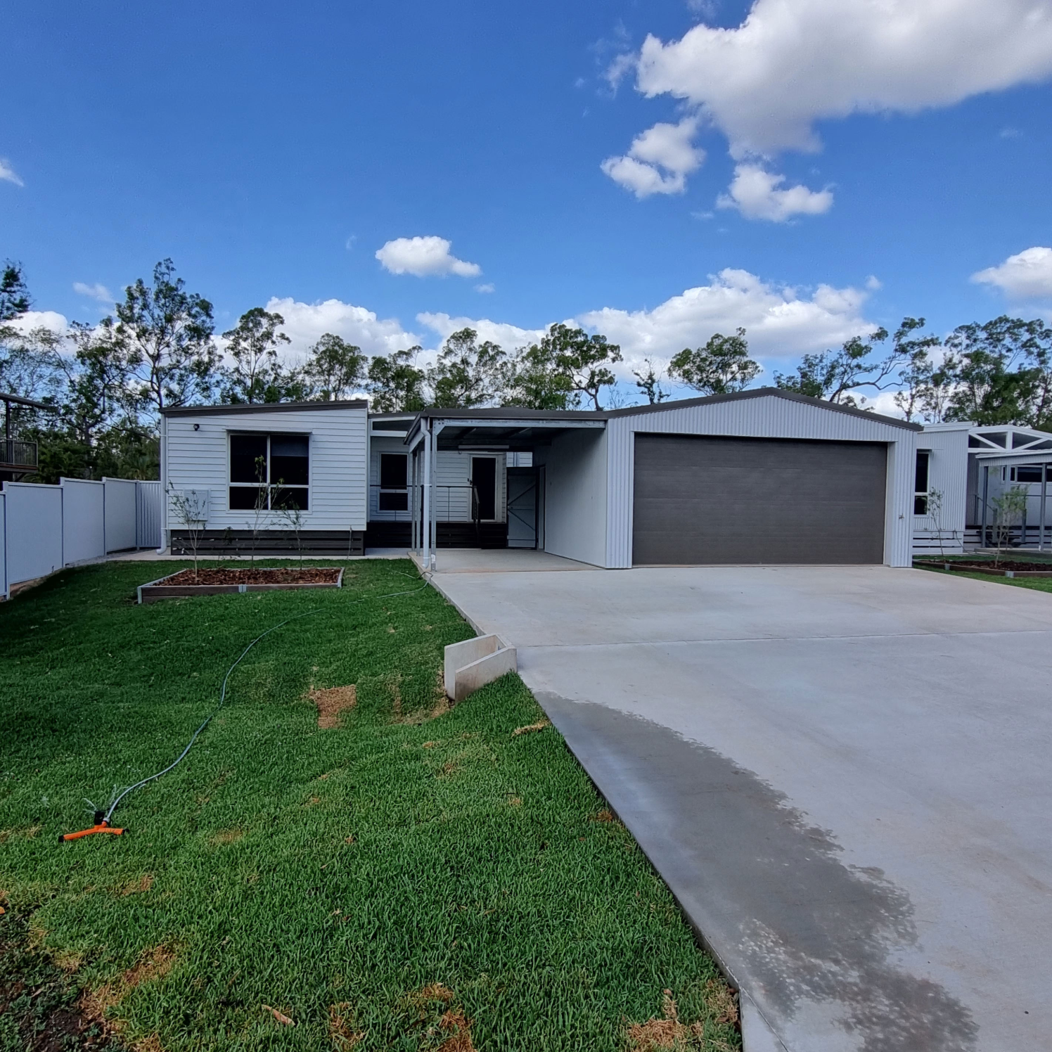 Front view of modular home with lawn and driveway