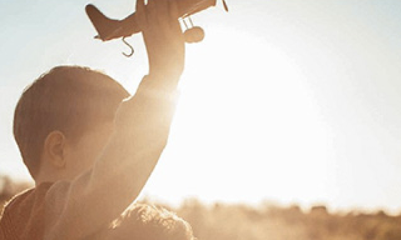 Boy with toy aeroplane