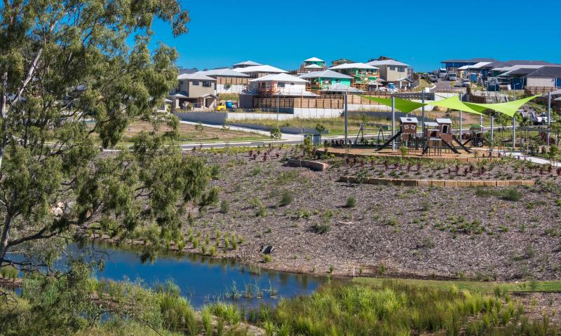 View of the Torhaven park and playground over a creek