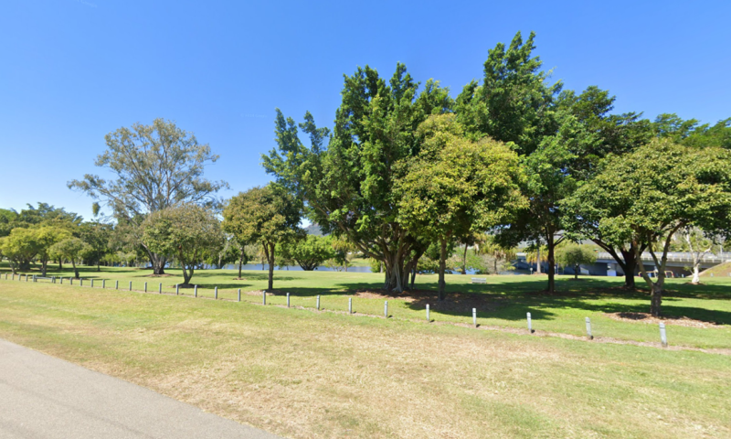 Green landscape showing trees, grass and a river in the background